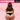 Person wearing black underwear with a pink piggy tail in the tail area on a pink background, featuring the brand 'TAILZ'.