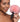 Woman holding a pink bunny tail against a white background