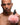 Man holding a pink fluffy bunny tail against a white background