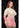 Woman wearing a ivory and pink lingerie dress against a patterned black background