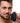 Man holding Trinity Men 10X Pleasure Stroke Vibrating Silicone Penis Sleeve on a white background