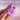 Purple rose-shaped toy held by a hand with a soft pink background and text 'DON'T LET IT SLIP'.