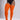 A model wearing bright orange ribbed thigh-high socks or stockings with a sheer black bodysuit, shown from the waist down against a light gray studio background.