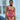 Woman wearing a pink lace lingerie set outdoors.