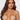 Woman with decorative jewelry on her breasts against a plain background