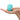 Turquoise rose-shaped vibrator held in a hand on a white background