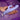 Hand holding Selopa Lavender Love Rabbit Vibrator against a textured purple background