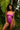 Woman wearing a purple lace lingerie set in a tropical setting