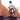 Hand holding a bottle of 'slippery kitty' hybrid intimate lubricant with a blurred background
