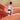 Bottle of Slippery Kitty silicone lubricant held by a person with a blurred background