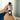 Hand holding a bottle of 'slippery kitty' intimate lubricant with a blurred background