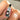 Hand holding a bottle of 'Slippery Kitty' lubricant with branding elements.