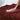 Red blanket with a hand touching a white substance on top
