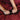 Close-up of hands with a gold ring on a red fabric background