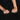 Close-up of two hands with a ring on a dark background