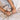 Close-up of two hands squeezing a beige blanket.