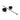 Black leather cuffs with metal spreader bar on a white background
