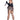 A woman modeling a revealing black and brown harlequin-patterned costume with matching garter belt, fishnet stockings, black boots, and a small black hat, posed against a plain white background while holding a knife prop.