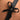 Black leather harness with a bow detail on skin