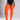 A model wearing bright orange ribbed thigh-high stockings with a black bodysuit, shown from the waist down against a light gray studio background.
