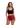 Woman wearing a black crop top and red shorts with black heart patterns on a white background