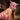 Person wearing a pink pig mask and lingerie in an industrial setting