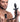 Man holding a black silicone Remote Control Wagging and Vibrating Puppy Tail Anal Plug on a white background