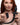 Woman holding a black Remote Control Wagging and Vibrating Puppy Tail Anal Plug against a white background