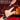 The Tickler Vibrating Silicone Tickler 'Bound & Squirming' with hands and candles on a dark background.