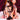 Man and woman with woman wearing sei mio trussed issues sitting on a bed with a blurred background