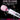 White and pink electronic wand with cleaning instructions on a black background with bubbles.