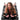 Woman lying on a black bondage board with restraints.